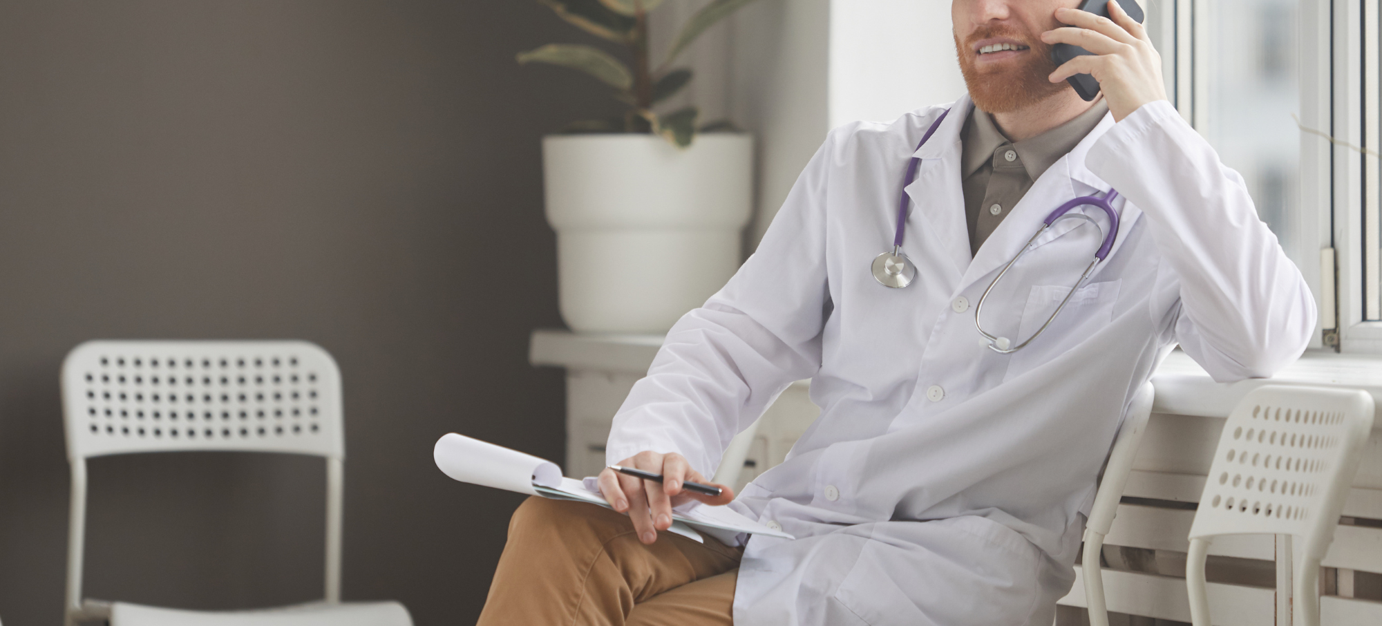 male clinician making call on mobile phone