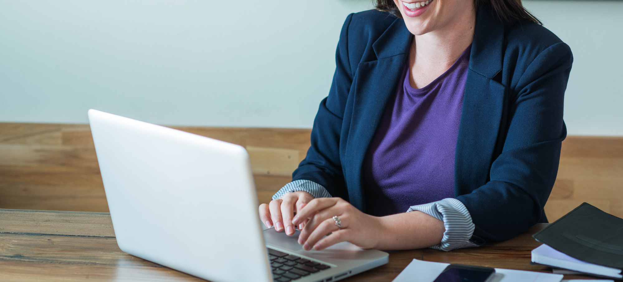 female clinician types on laptop