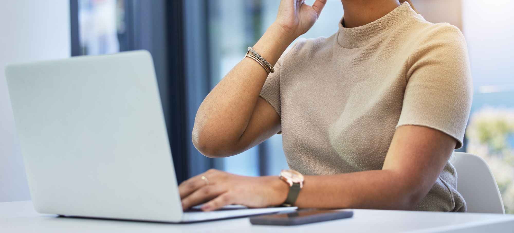 female clinician working on laptop