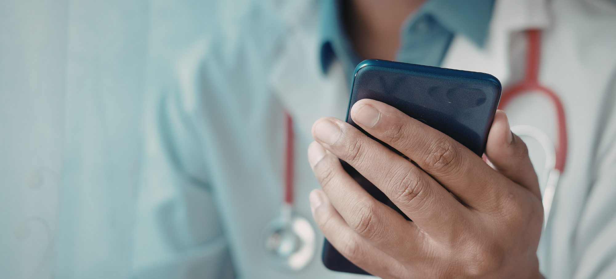 male clinician holding phone, referral triage